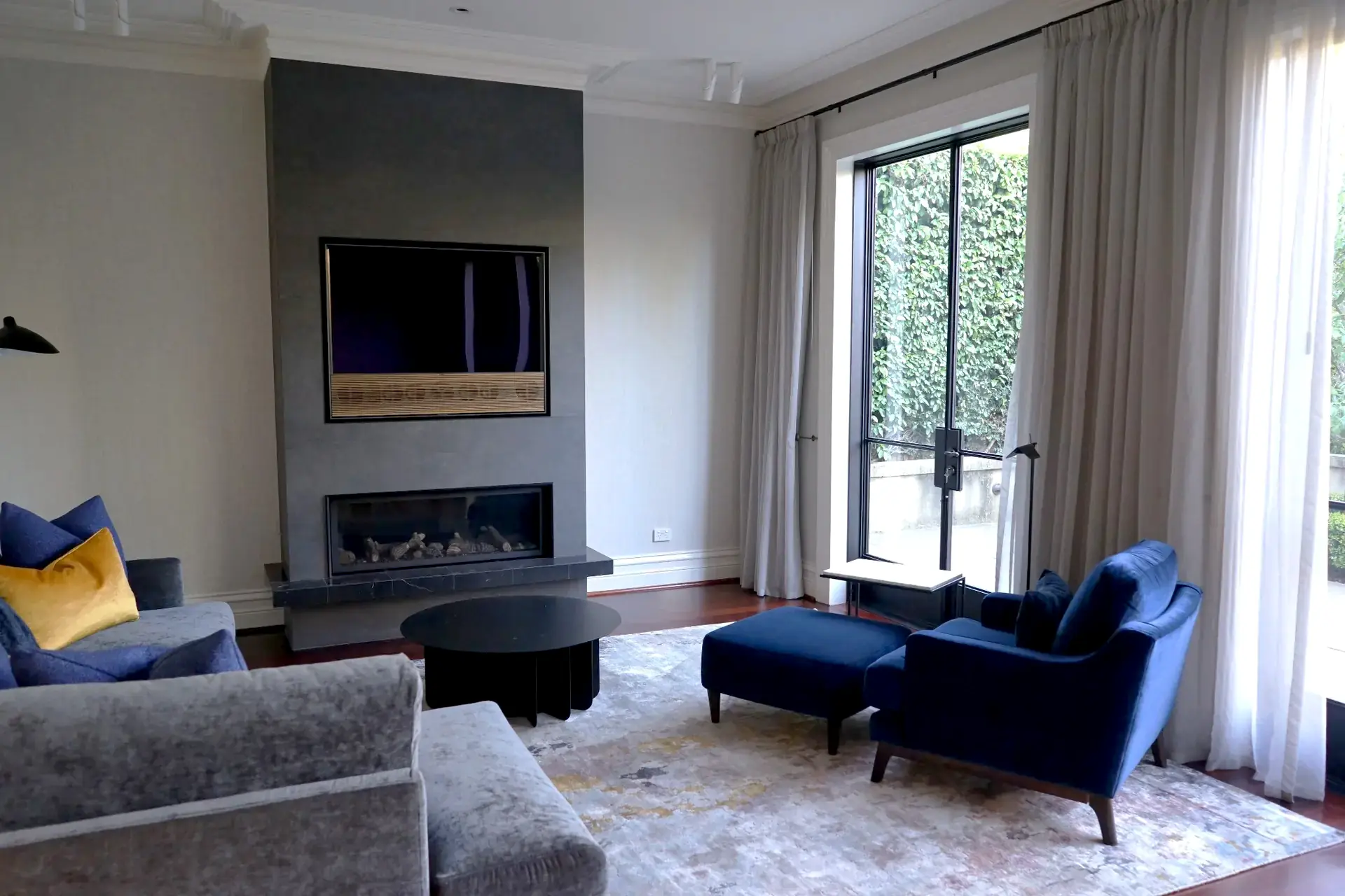 Living room with fireplace and TV console in Nedlands residence, Perth interior design