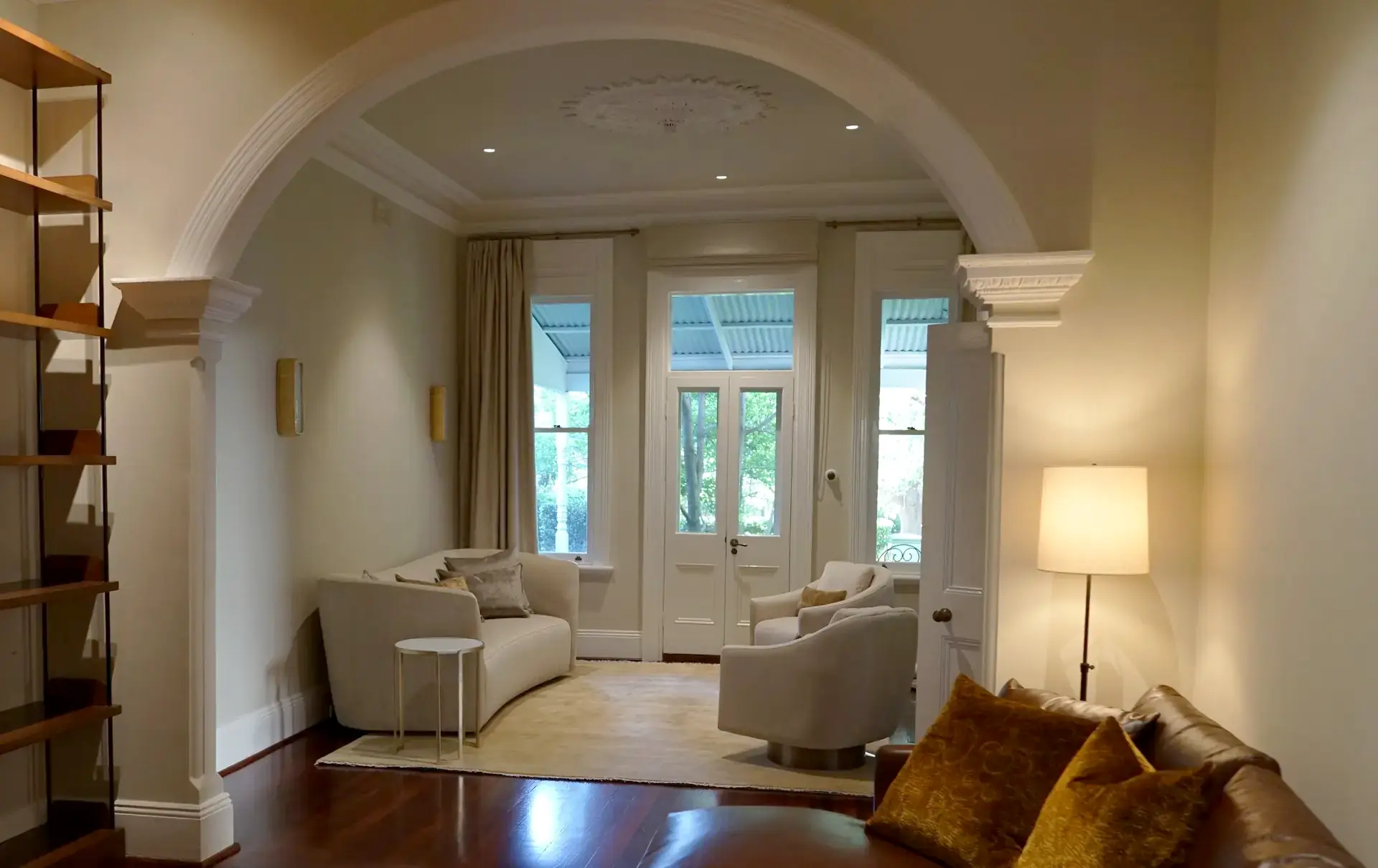 Lounge room with archway and armchairs in Nedlands residence, Perth interior design