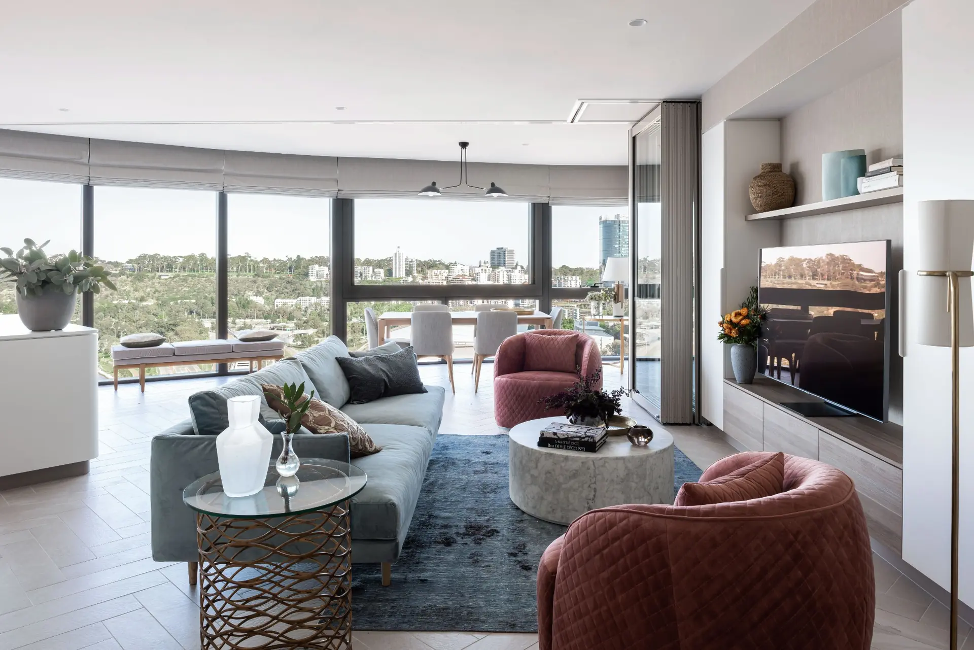 Living room with red armchairs and city views in Elizabeth Quay Ritz-Carlton apartment, Perth