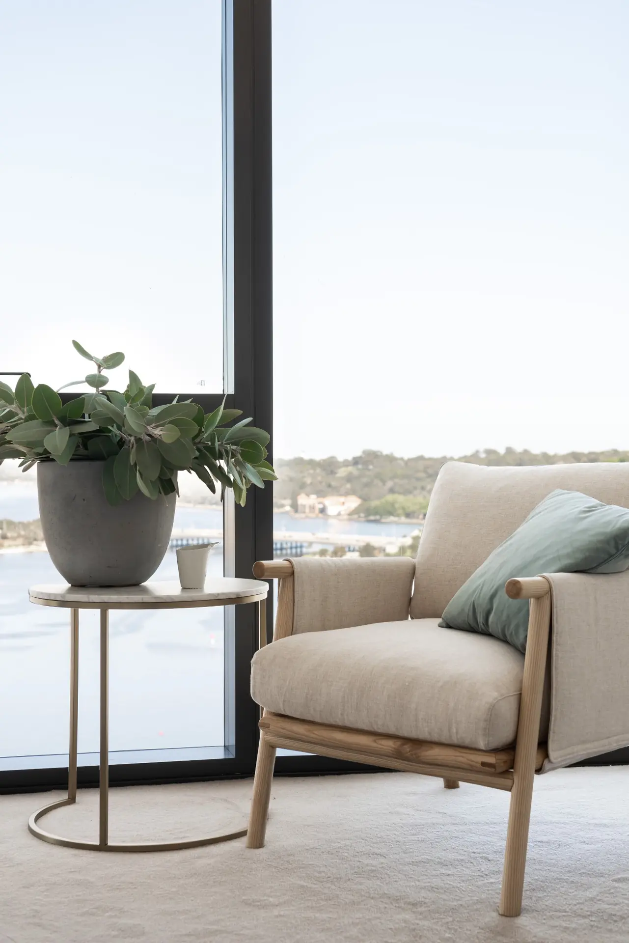 Living area opening onto balcony with skyline views in Elizabeth Quay Ritz-Carlton apartment, Perth