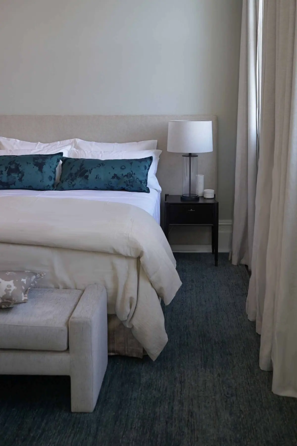 Layered white bedding and soft furnishings in a Fremantle residence bedroom, Perth
