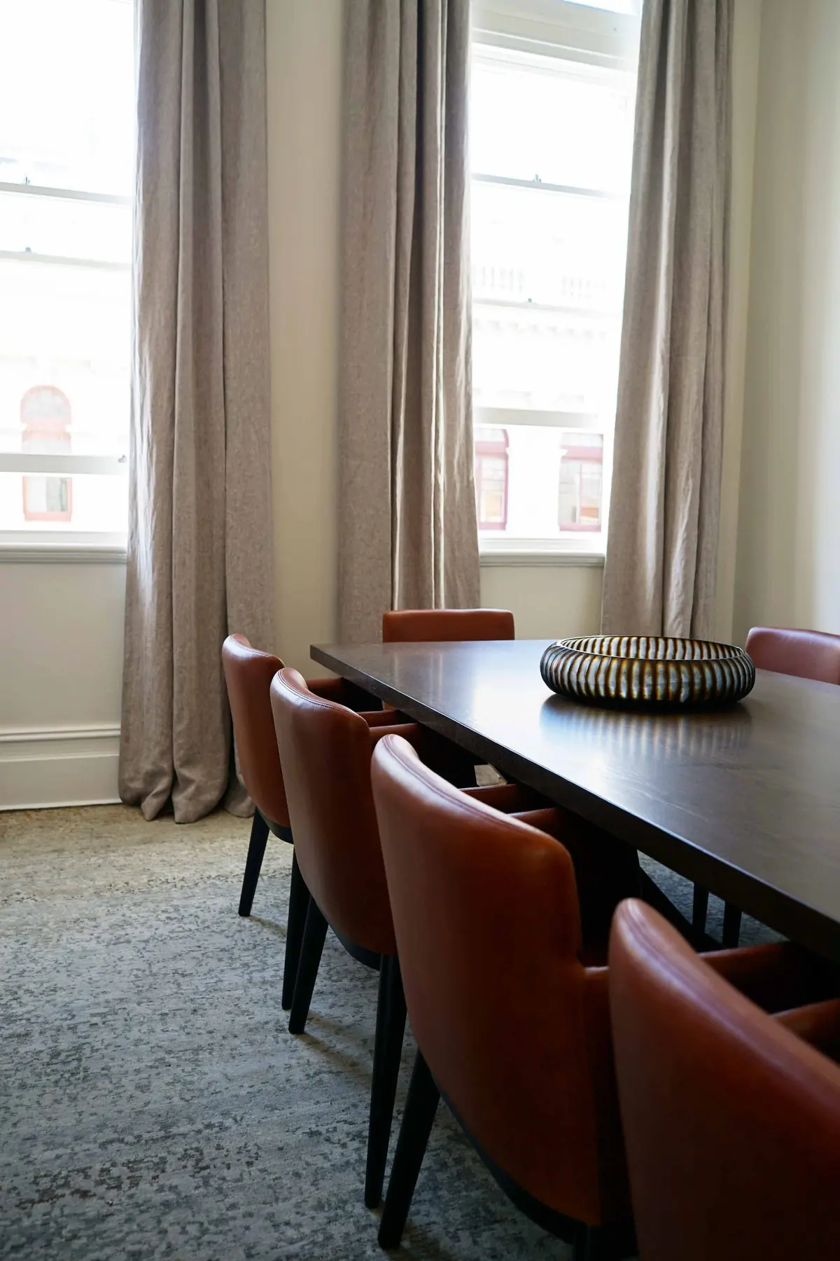 Dining table and chairs with sheer curtains in Fremantle residence, Perth interior design