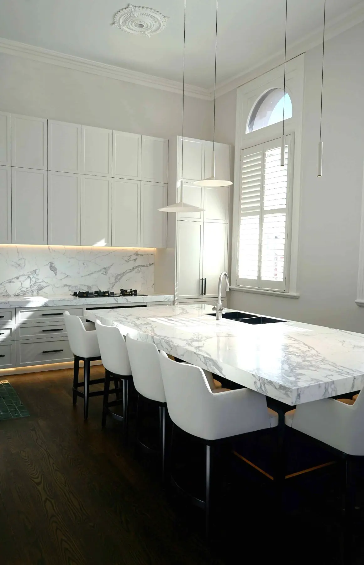 White kitchen with dining table in Fremantle residence, Perth interior design