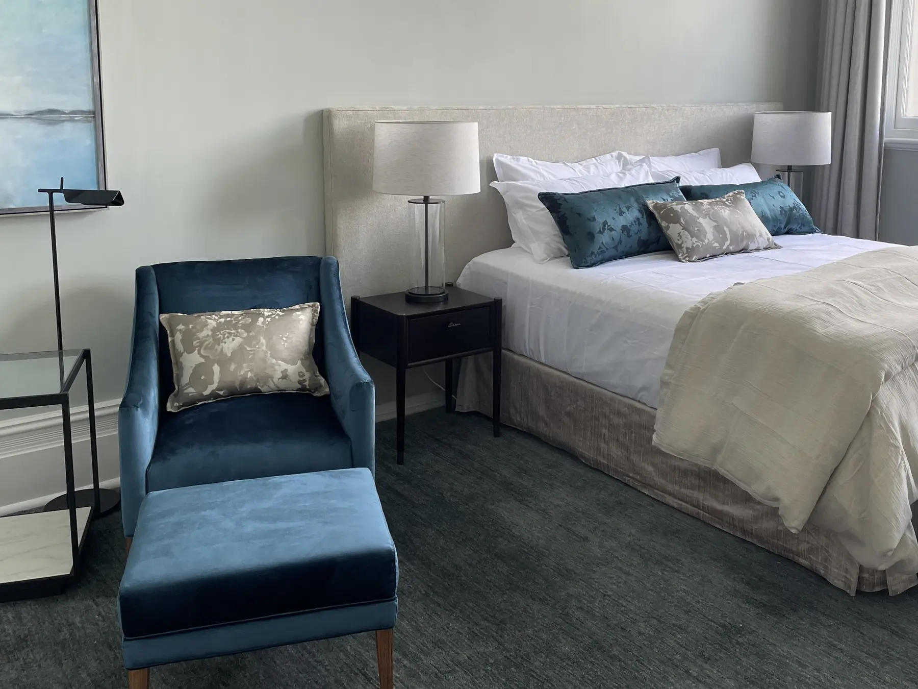 Blue upholstered bedhead with white linens in Fremantle residence master bedroom, Perth