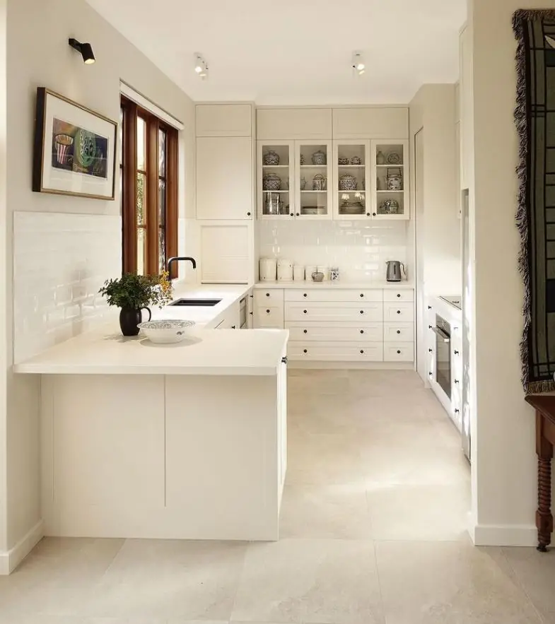 Cream shaker-style kitchen with timber-framed window in Mount Claremont residence, Perth interior design